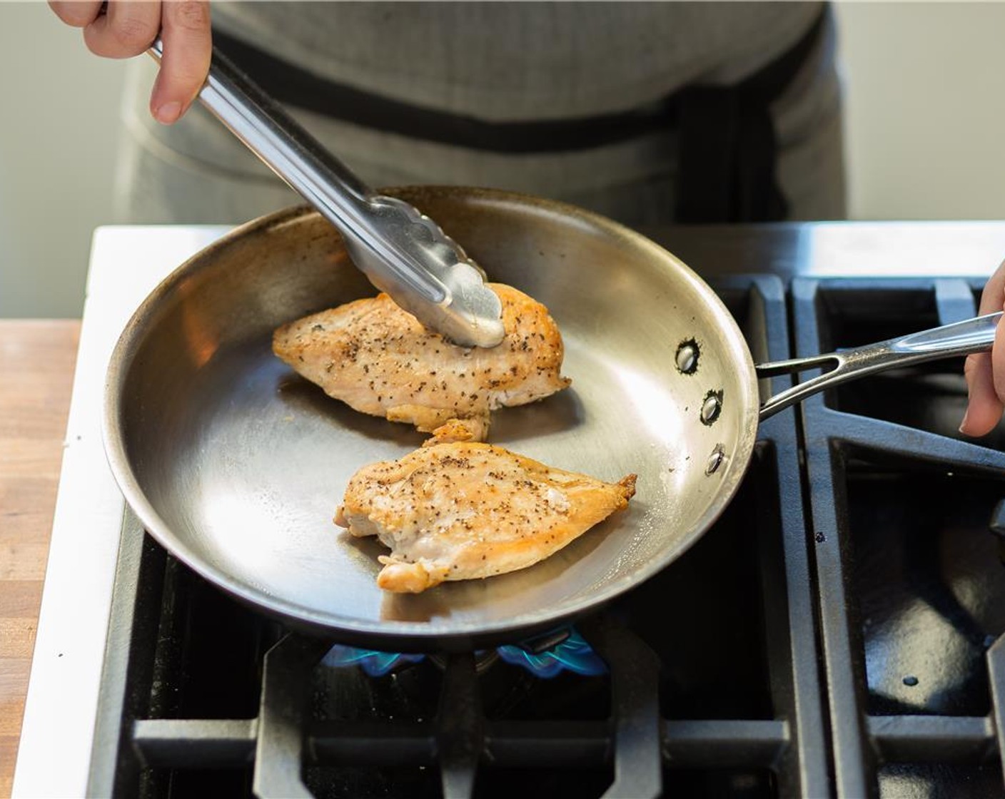 step 10 When hot, add the chicken and sear on each side for four minutes, or until cooked through.