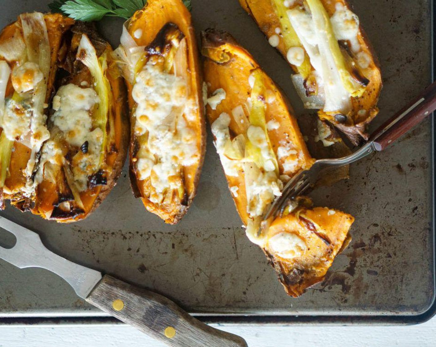 step 6 Cut the sweet potatoes in half and lightly season the insides with Salt (to taste) and Ground Black Pepper (to taste) Top with the leeks and Gorgonzola Cheese (to taste).