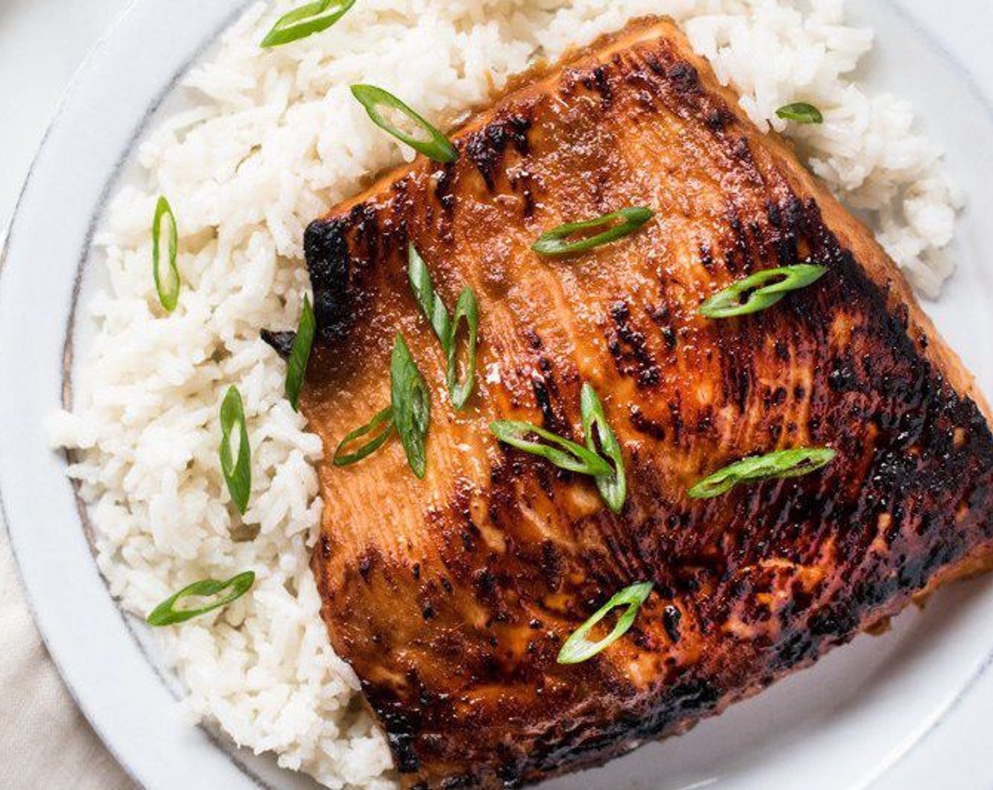 step 8 Place the coconut rice and miso-glazed salmon on a plate. Top with Scallion (1 bunch) serve, and enjoy!