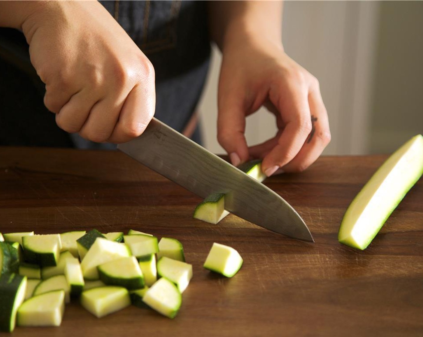 step 2 Cut Zucchini (1) in half lengthwise. Slice each half lengthwise again to create four long quarters, then slice widthwise into half inch pieces.