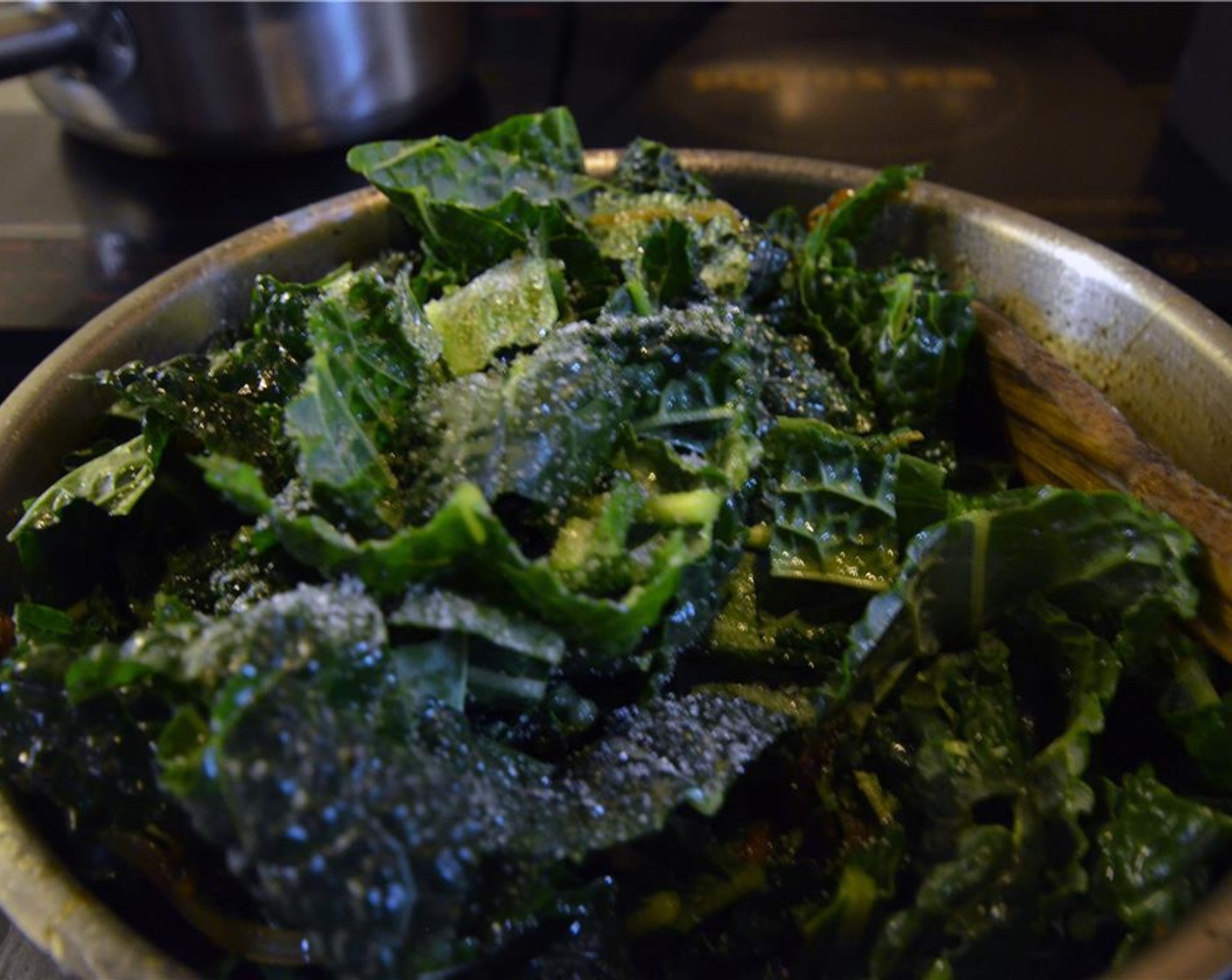 step 8 Add kale to the onions, along with the Granulated Sugar (1 Tbsp) and a heavy pinch of Salt (to taste) and Ground Black Pepper (to taste).