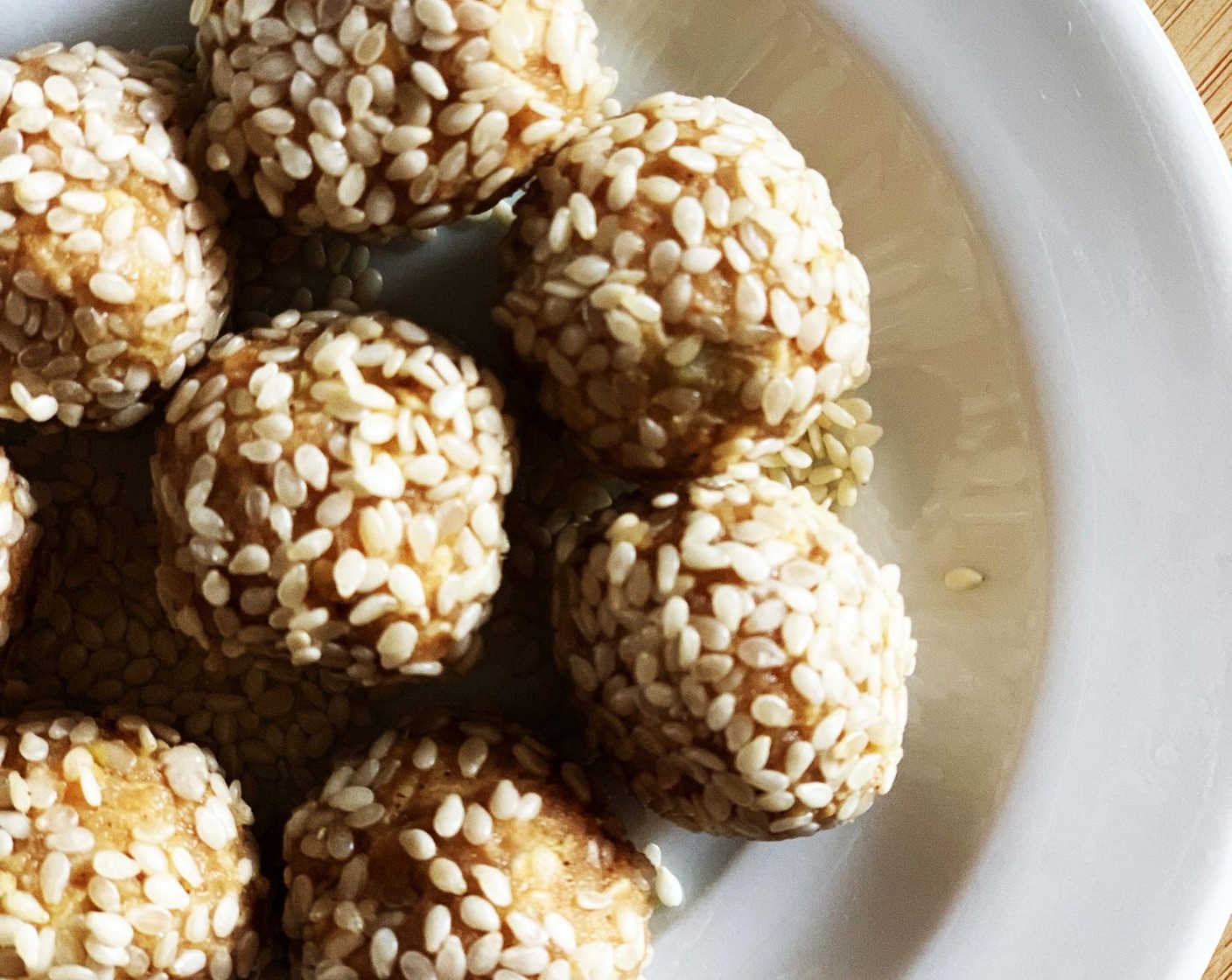 step 3 Roll out the dough into small balls. Roll each ball into White Sesame Seeds (1 Tbsp). Refrigerate until ready to serve.