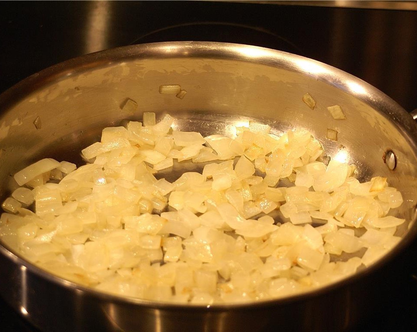 step 2 Saute the Onion (1) in Extra-Virgin Olive Oil (2 Tbsp) on low heat until translucent and golden. Add the Garlic (3 cloves) and sauté for another minute, or until fragrant.