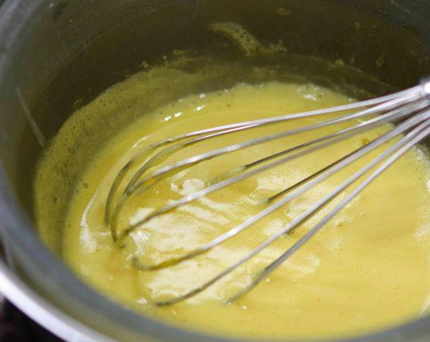 step 3 Add the Distilled White Vinegar (1 tsp) and Salt (1 pinch) to give the Hollandaise a lovely light color and a tangy flavor. Remember to keep the water under your bain marie gently warmed but not boiling or simmering to ensure that you don’t end up with scrambled eggs. If your sauce is getting too hot and clumping, simply remove from the heat and add a touch of Water (1 tsp) to dilute.