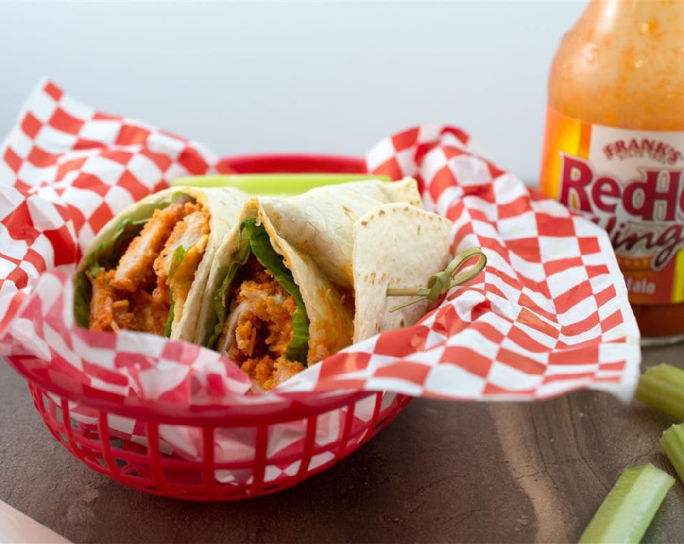 step 11 Place a tortilla on a flat work surface and top with a piece of Romaine Lettuce (2 pieces), half of the chicken, half of the shredded cheese, half of the Ranch Dressing (2 Tbsp) and roll it up. Repeat again for the second wrap. Cut each in half and enjoy!