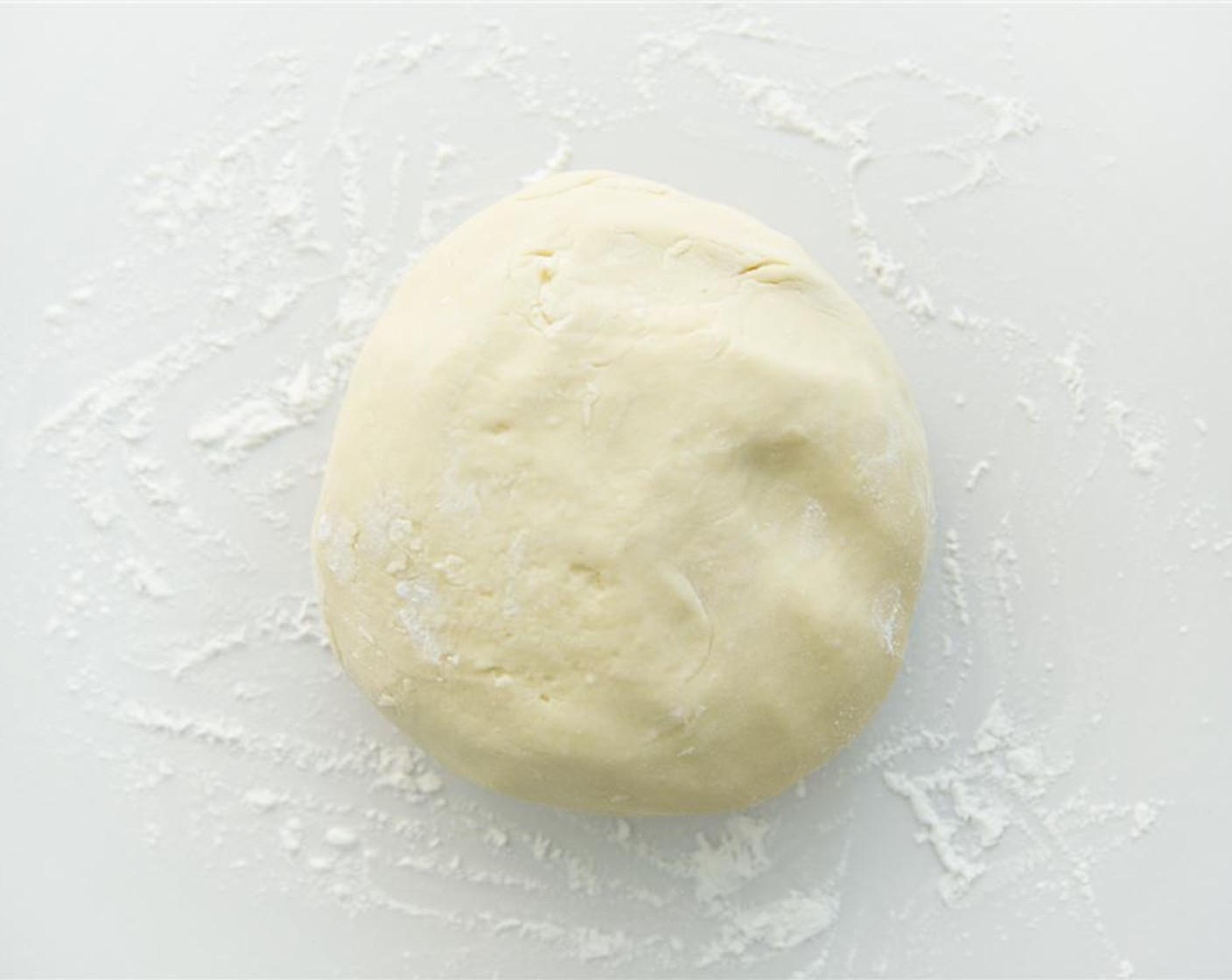 step 5 Transfer the dough to a surface dusted with sticky rice and knead while slowly incorporating sticky Sweet Glutinous Rice Flour (1 cup). Once the dough is smooth and does not stick to your hands, sprinkle some flour on it and roll it until it is 3/4 inches (2 centimeters) thick.