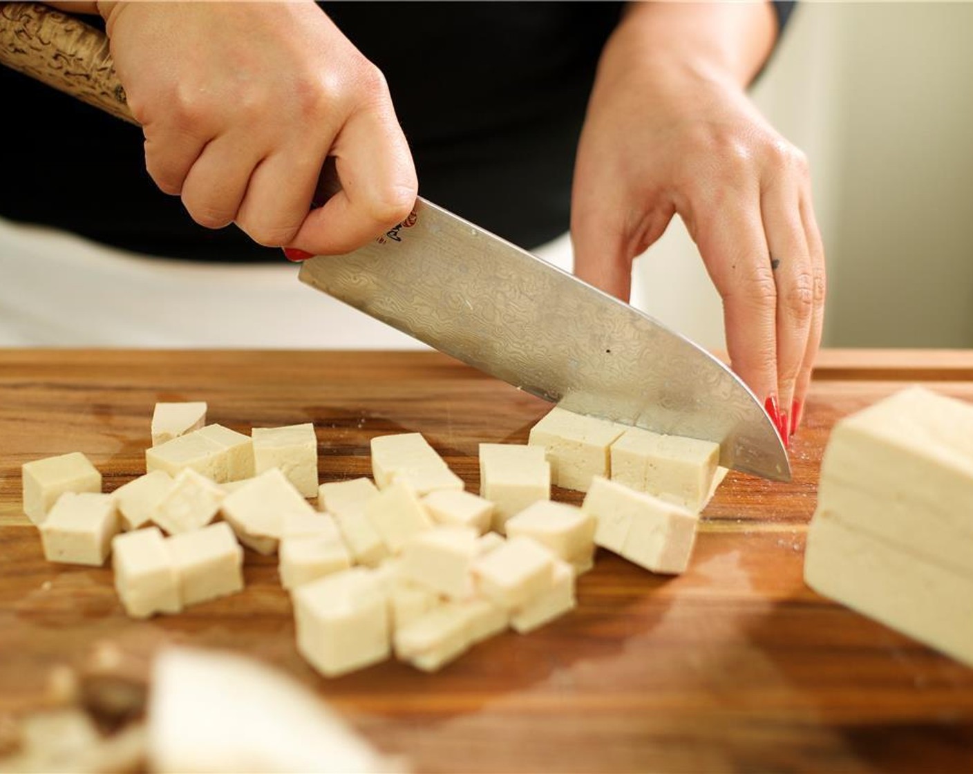 step 1 Peel Fresh Ginger (1 Tbsp) using the back of a spoon and mince. Place into a small bowl. Mince Garlic (2 cloves) and place into a bowl with ginger and set aside. Pat the Extra Firm Tofu (1) dry with paper towels. Cut into half inch cubes and set aside.