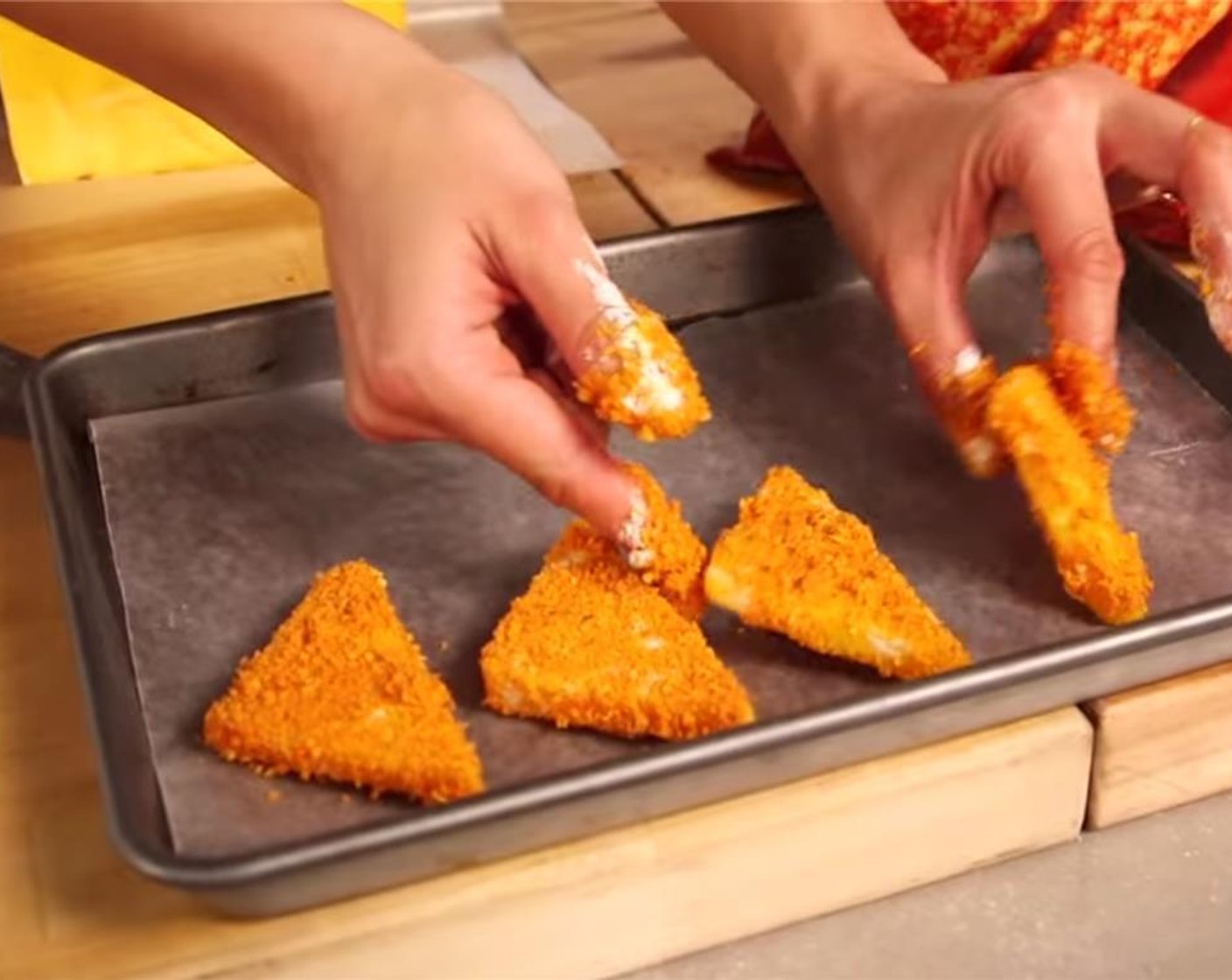 step 5 Take each triangle of cheese, and coat in flour. Quickly dip into the eggs wash, and then coat thoroughly in the Doritos crumbs. Lay onto a cookie sheet. Repeat.  Freeze the Doritos-coated cheese triangles for at least 3 hours before frying.