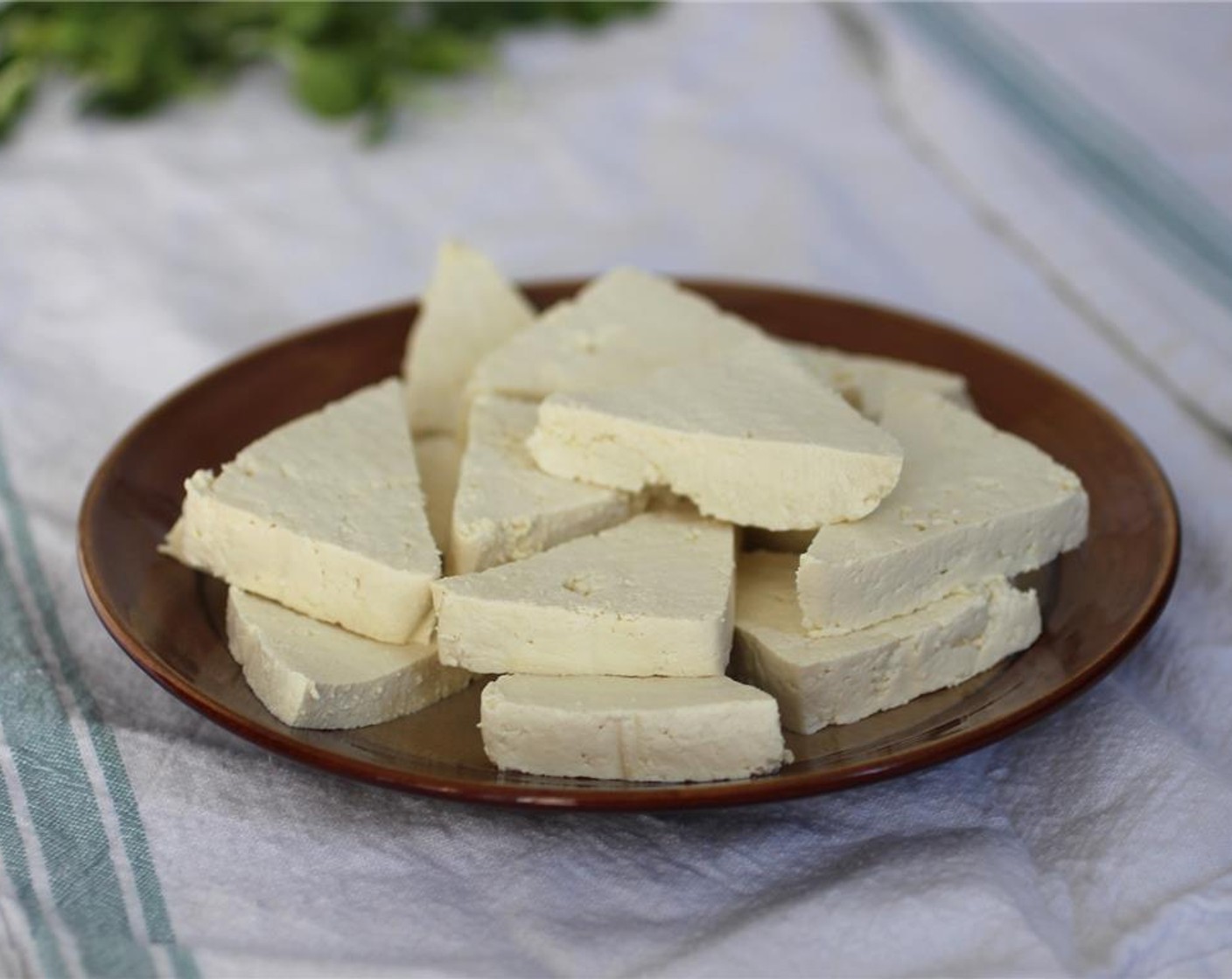 step 1 Drain the Tofu (1 block) between paper towel or a kitchen towel under a heavy pan or book for at least 30 minutes. Cut tofu into squares or triangles.