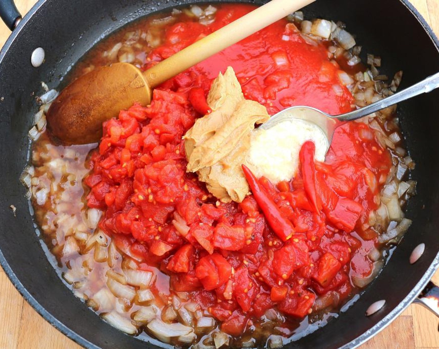 step 6 Add Canned Diced Tomatoes (1 1/4 cups), Canned Tomato Purée (1 cup), Peanut Butter (1/3 cup), Hot Chili Peppers (to taste), Garlic Paste (1 Tbsp), Kosher Salt (to taste) and Cayenne Pepper (to taste). Saute for 3 minutes until bubbly