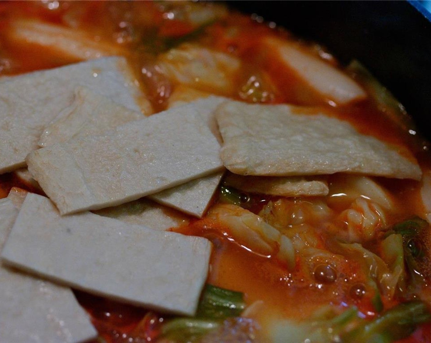 step 15 Add the fish cake and garlic. Continue to simmer for 10 minutes, until the sauce gets quite thick.