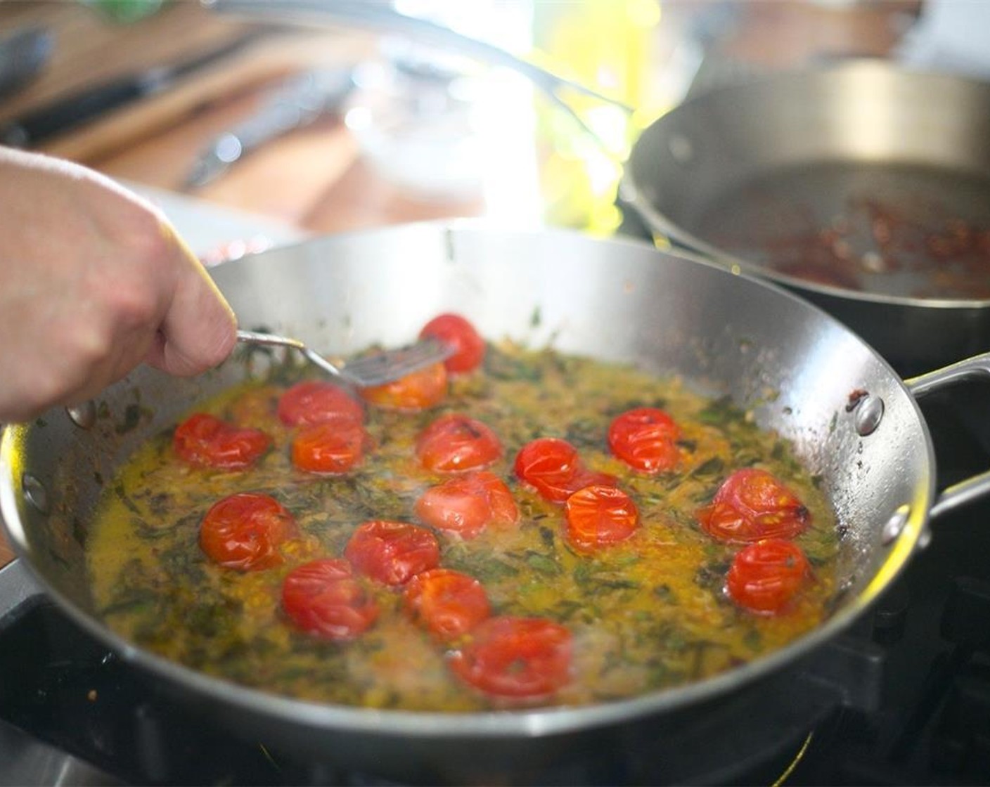 step 14 Cook for three minutes or until tomatoes begin to blister and pop. Remove from heat and hold until plating.