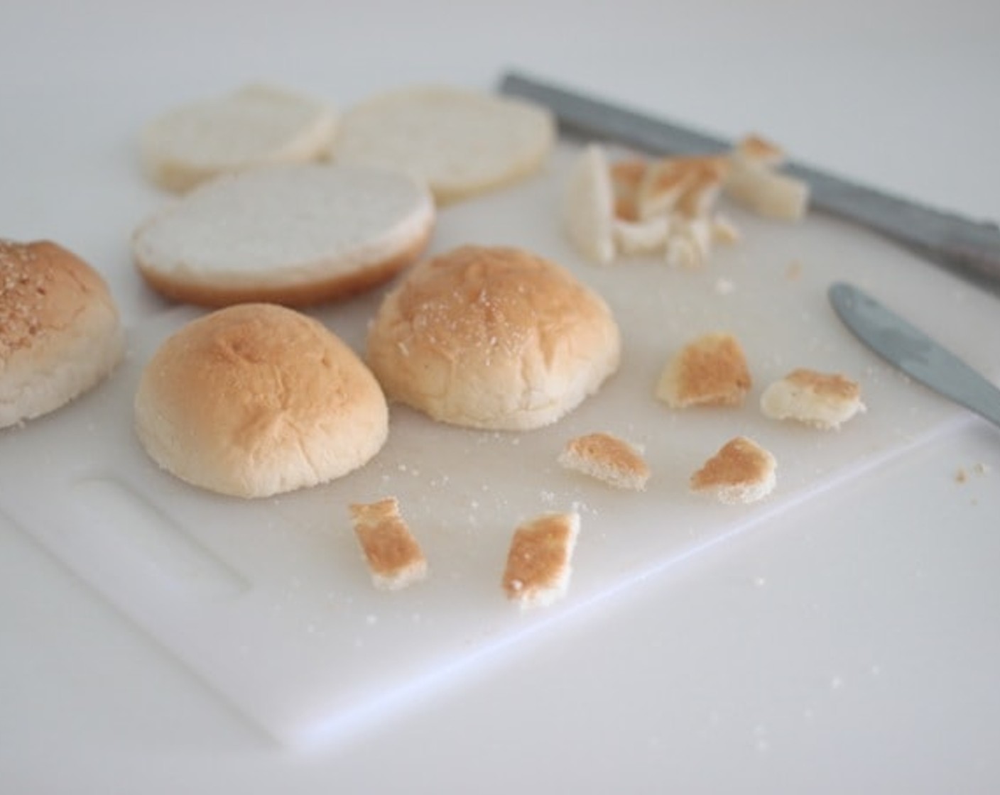 step 8 Use a bread knife to cut the Hamburger Buns (3) in half. Make the bear limbs with the extra Slider Buns (6). I used a table knife to cut off the small details.