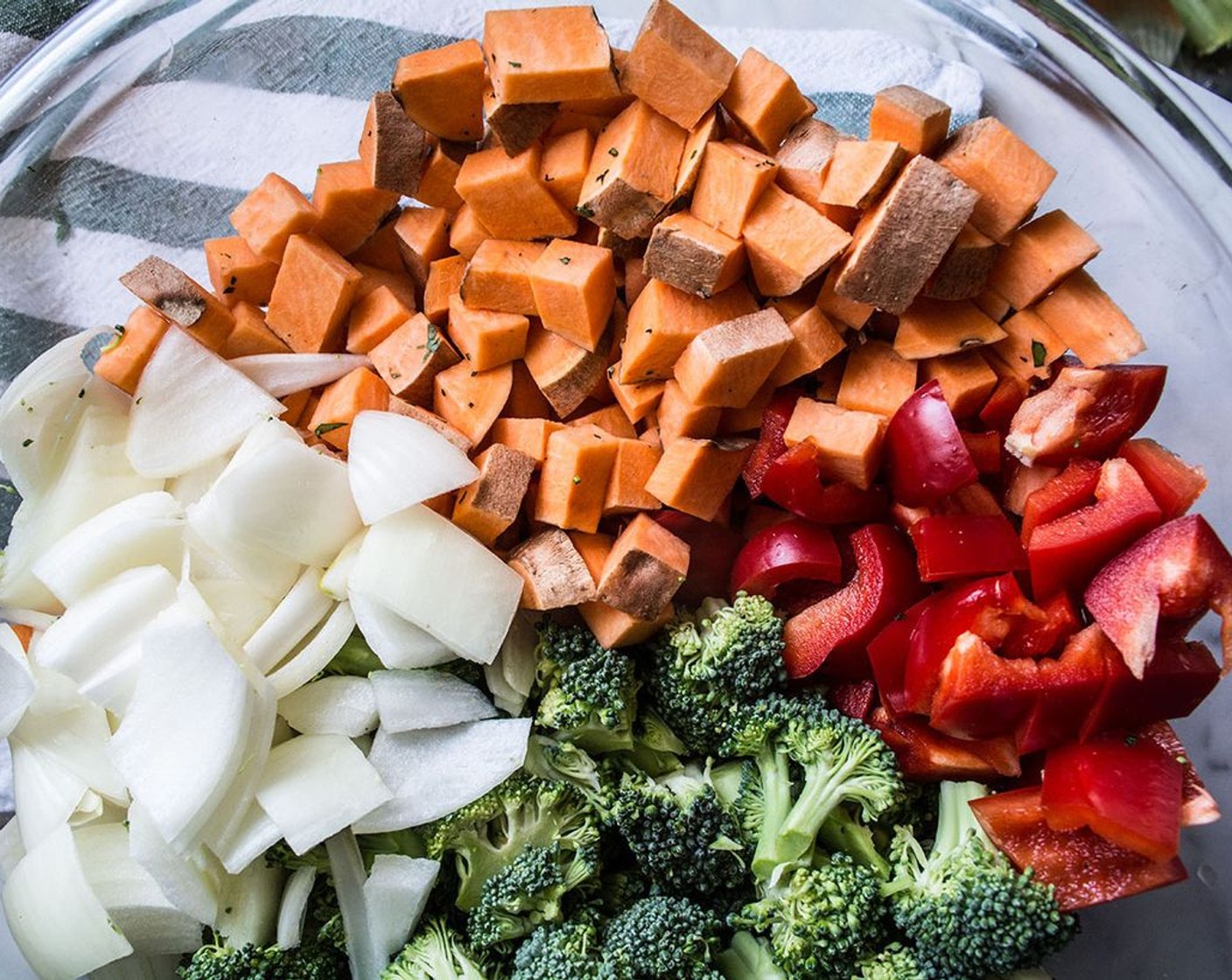 step 4 While the rice cooks spread the Sweet Potatoes (3 cups), Broccoli (2 heads), Red Bell Pepper (1), and Sweet Onion (1) evenly among two baking sheets. Bake for 15 minutes, remove and stir, then bake additional 10 minutes or until all veggies are cooked to your preference.