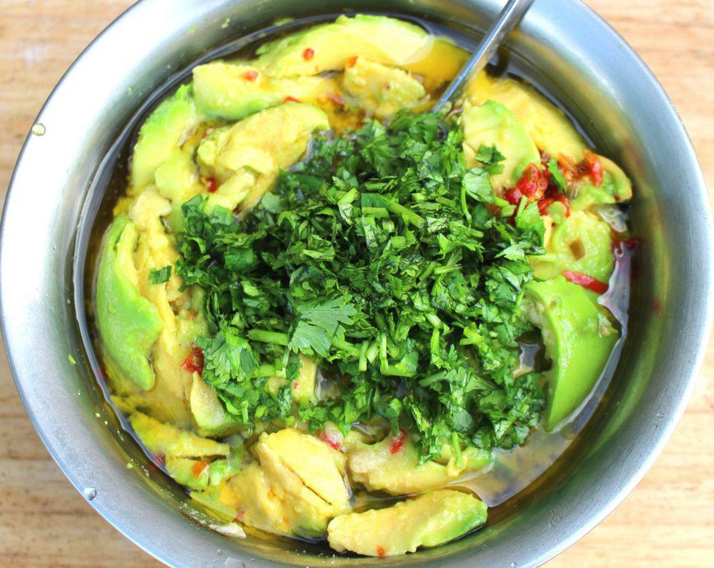 step 5 Add chopped cilantro to the bowl, mash all ingredients coarsely together, check and adjust seasonings to taste.