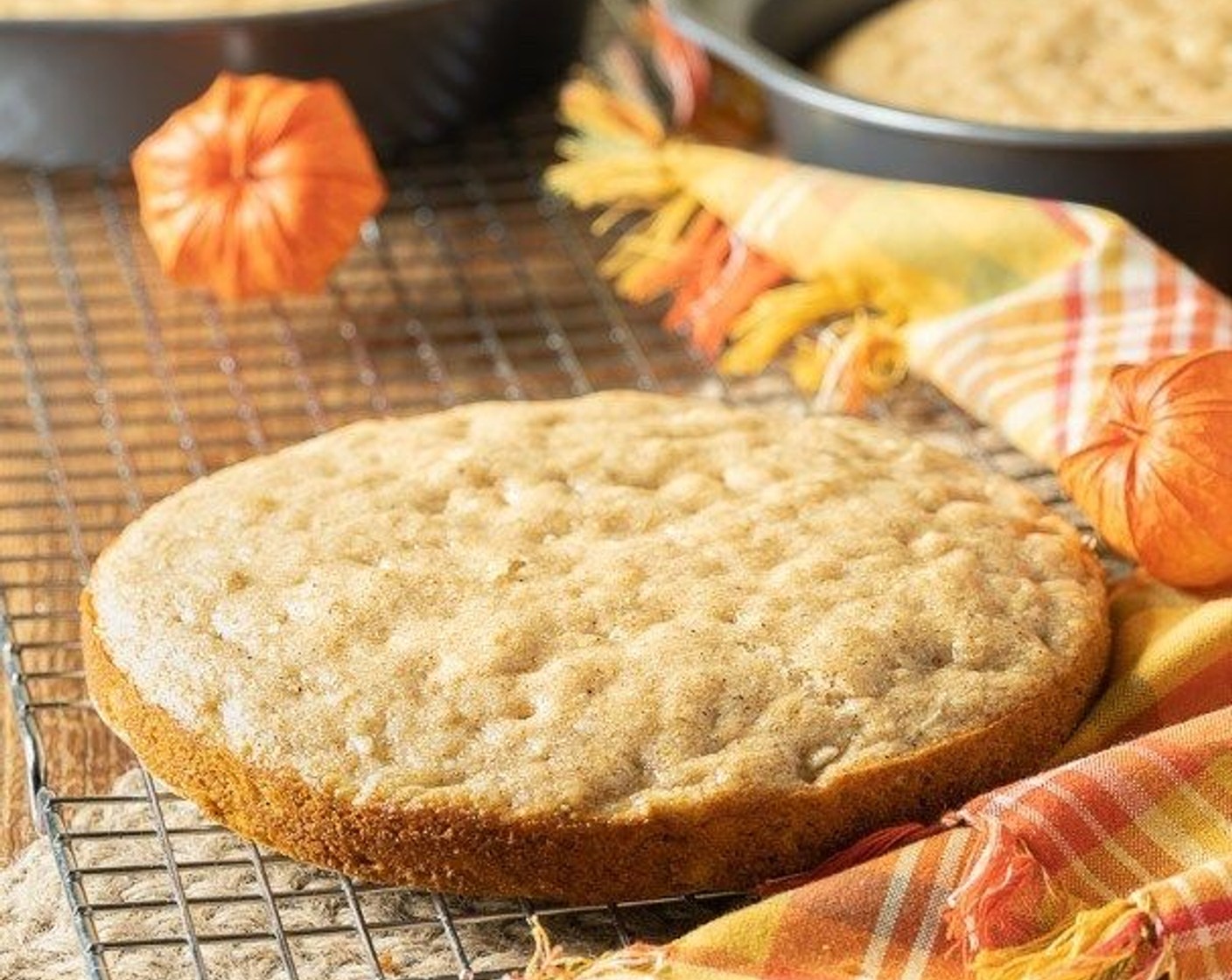 step 7 Remove cake from pans and peel off parchment. Brush each layer with the simple syrup. Arrange one layer on a serving plate and spread with approximately 1/4 of icing. Top with another layer and repeat with icing and top with the remaining cake layer.