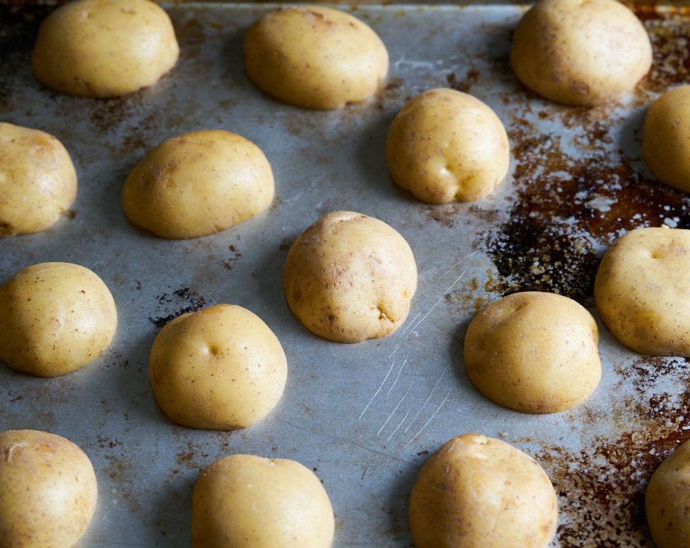 step 2 Choose smaller Yukon Gold Potatoes (4 1/2 cups) and try to use ones that are as close to the same size as possible. Cut potatoes in half. Arrange cut side down on a sheet pan. Don’t overcrowd the pan.