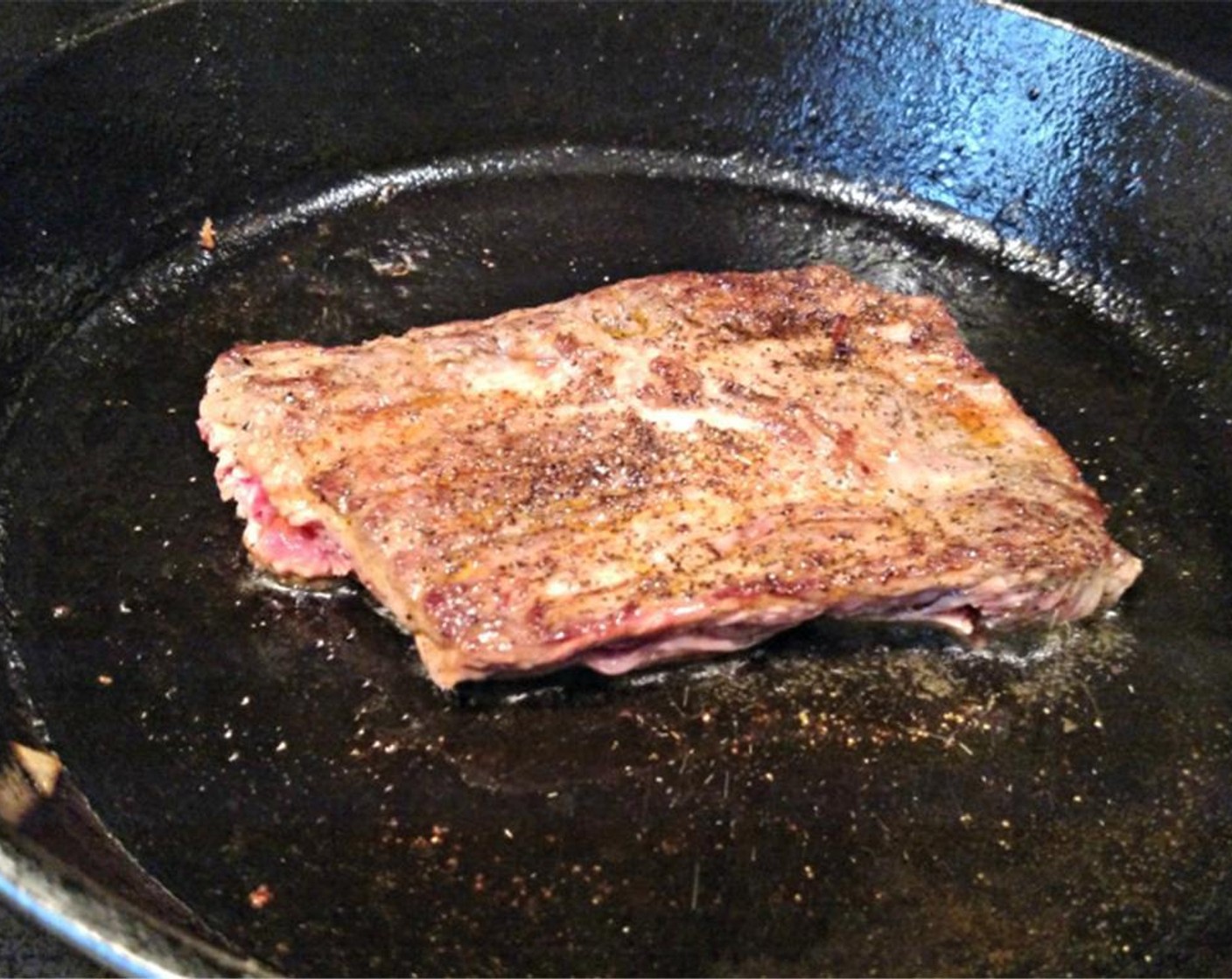 step 5 Once your beef has rested after being tenderized, cut the beef into equal portions and heat up the skillet you used to saute the vegetables. Add another tablespoon or so of extra virgin olive oil and cook beef for two and a half minutes on one side over medium heat.