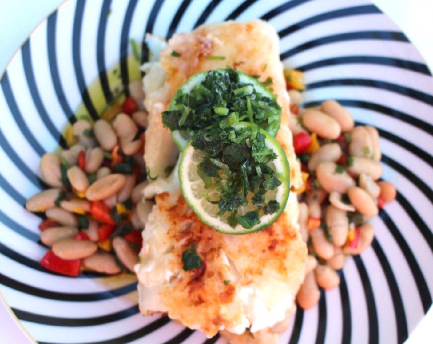 step 8 Top the fish with Limes (to taste), then garnish with Italian Flat-Leaf Parsley (to taste).