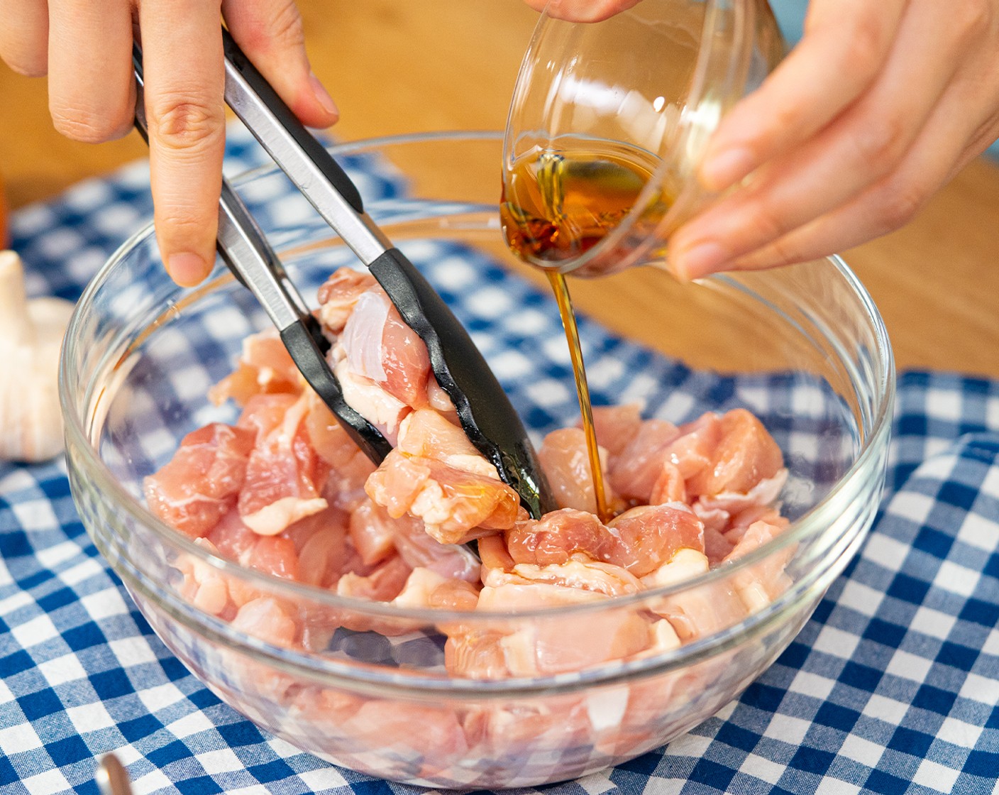 step 1 Cut Boneless, Skinless Chicken Thigh (1 lb) into bite-size pieces (around 1-inch). Add to a bowl with the Sesame Oil (1/2 Tbsp). Toss until well coated and set aside.