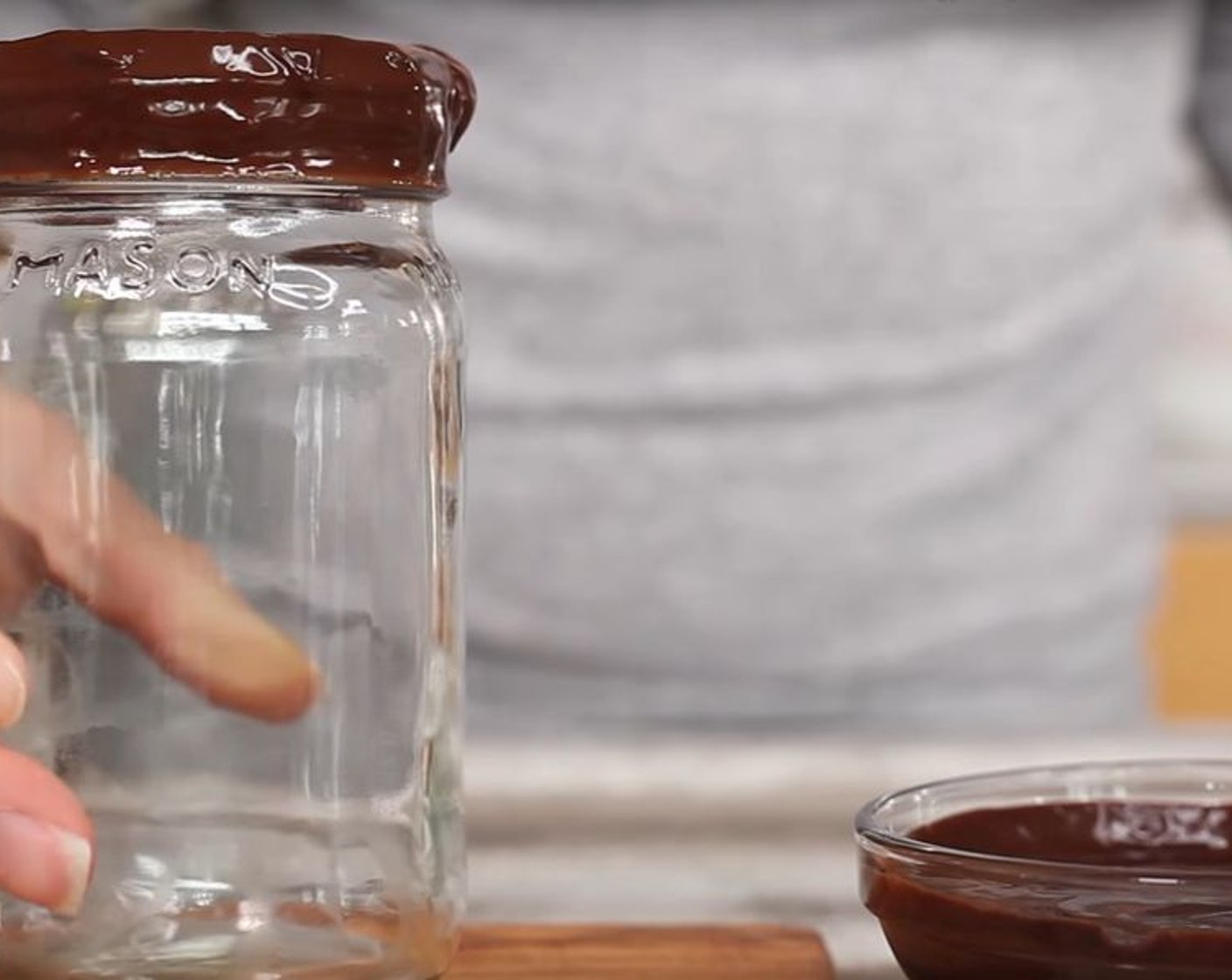 step 1 If you want, place your chocolate sauce into a small ramekin or dish wider than your glass for rimming. Place the opening of the glass into the sauce to rim and place glass in the fridge or freezer for a couple of mins so the chocolate can become hard. This step is completely optional.