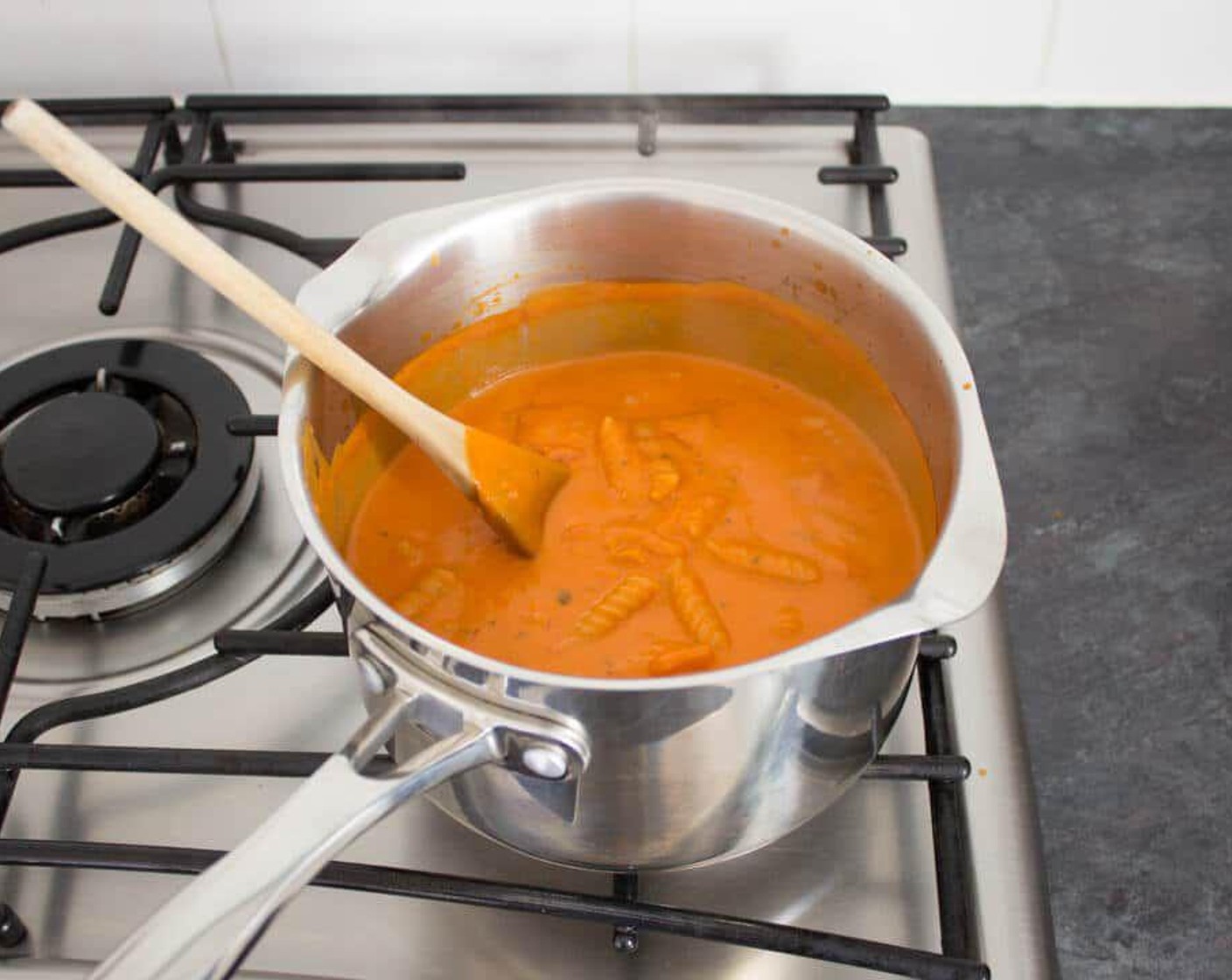 step 3 Reduce the heat so it’s nicely bubbling away but not violently. Boil for 10-12 minutes until the pasta is cooked to your liking. Stir frequently to prevent the pasta from sticking to the bottom of the pan.