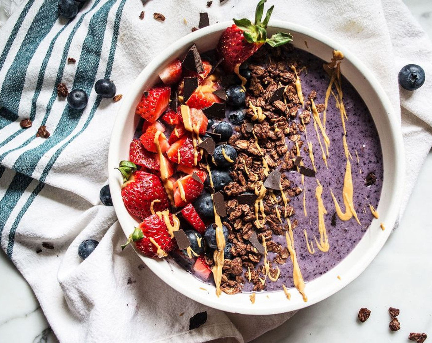 step 2 Add to bowl and top with Chocolate Granola (to taste), Fresh Strawberries (to taste), Fresh Blueberries (to taste), Cacao Nibs (to taste), and Creamy Peanut Butter (to taste). Enjoy!