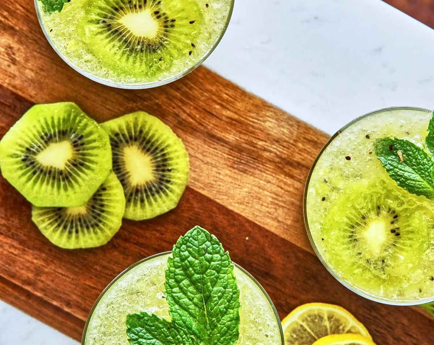 step 3 Top with a slice of Kiwifruit (1) and a sprig of Fresh Mint (1 bunch). Serve immediately.