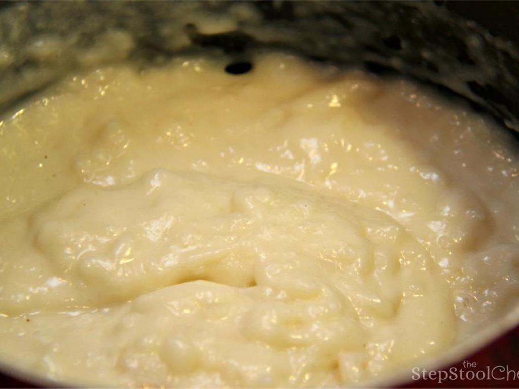 Step 7 of Simple Vanilla Soufflé Recipe: Next, return the batter to the stove and bring the mixture to a simmer, stirring constantly until it thickens.