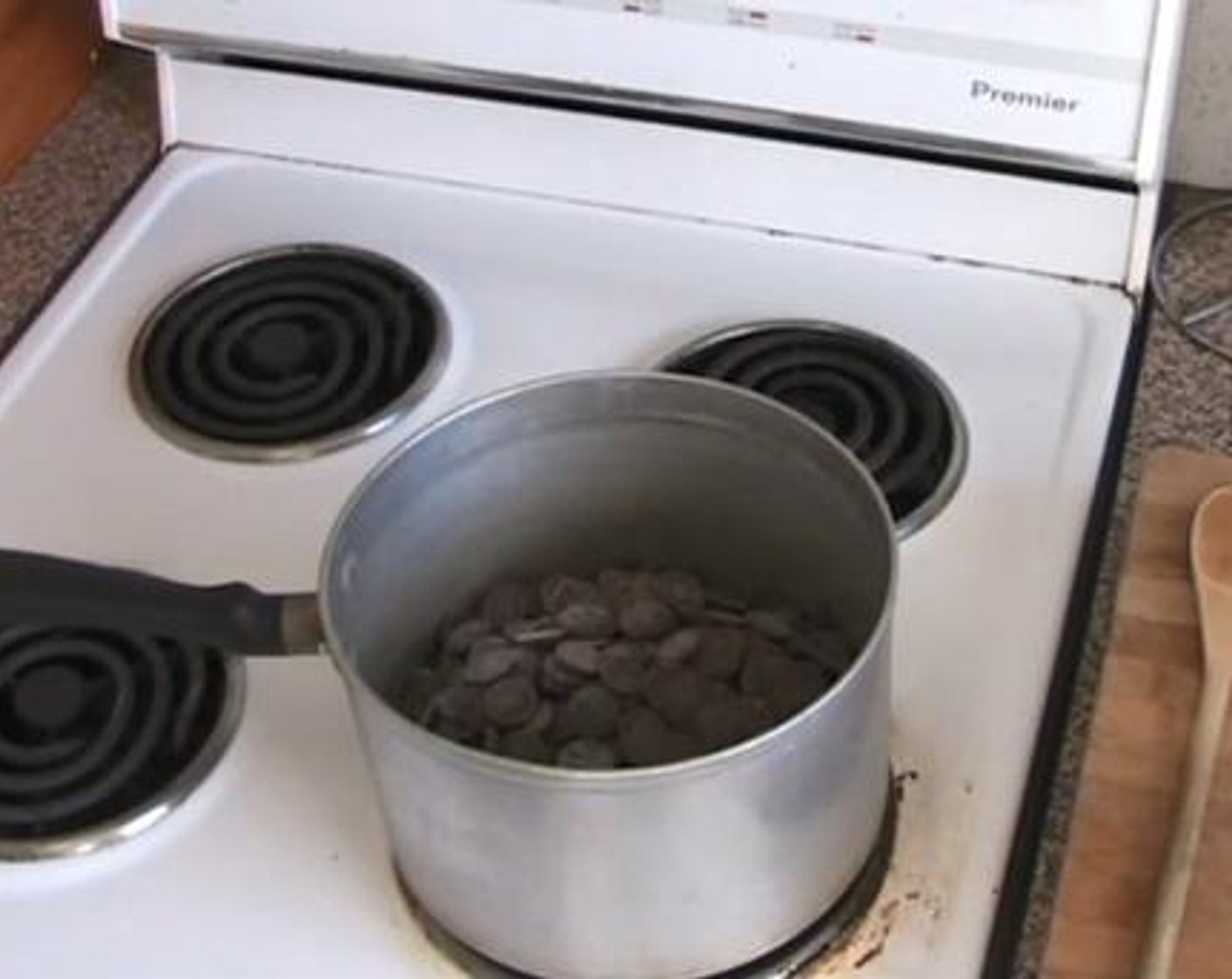 step 2 In a saucepan under very low heat, melt together the Unsalted Butter (3/4 cup), Brown Sugar (1 cup), and Dark Chocolate Chips (2 1/4 cups).