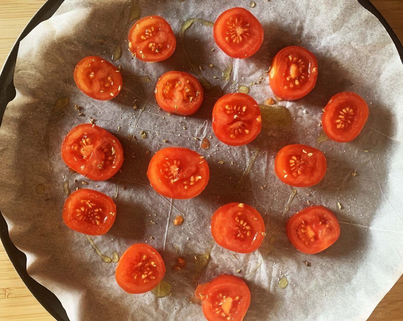 step 2 Wash and cut the Tomatoes on the Vine (8) in half. Season with Salt (to taste) and Ground Black Pepper (to taste), Dried Oregano (1/2 Tbsp), and Extra-Virgin Olive Oil (1 Tbsp).