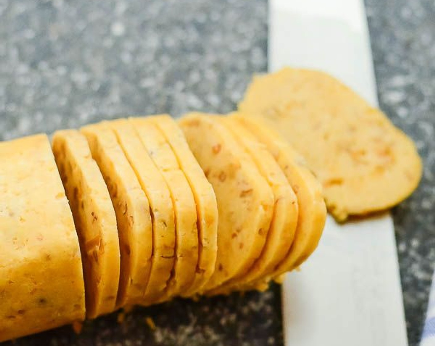 step 7 Unwrap logs and cut into slices with a very sharp knife into 1/8" thick rounds. Arrange 1" apart on the baking sheet.