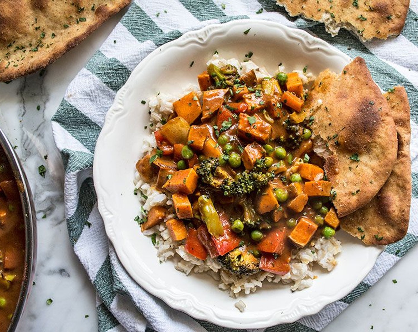 step 7 Once vegetables are cooked, add them to a large skillet with masala sauce, stir to combine. Serve over cooked brown rice, garnish with Fresh Cilantro (4 Tbsp) and serve with Flatbread (4).