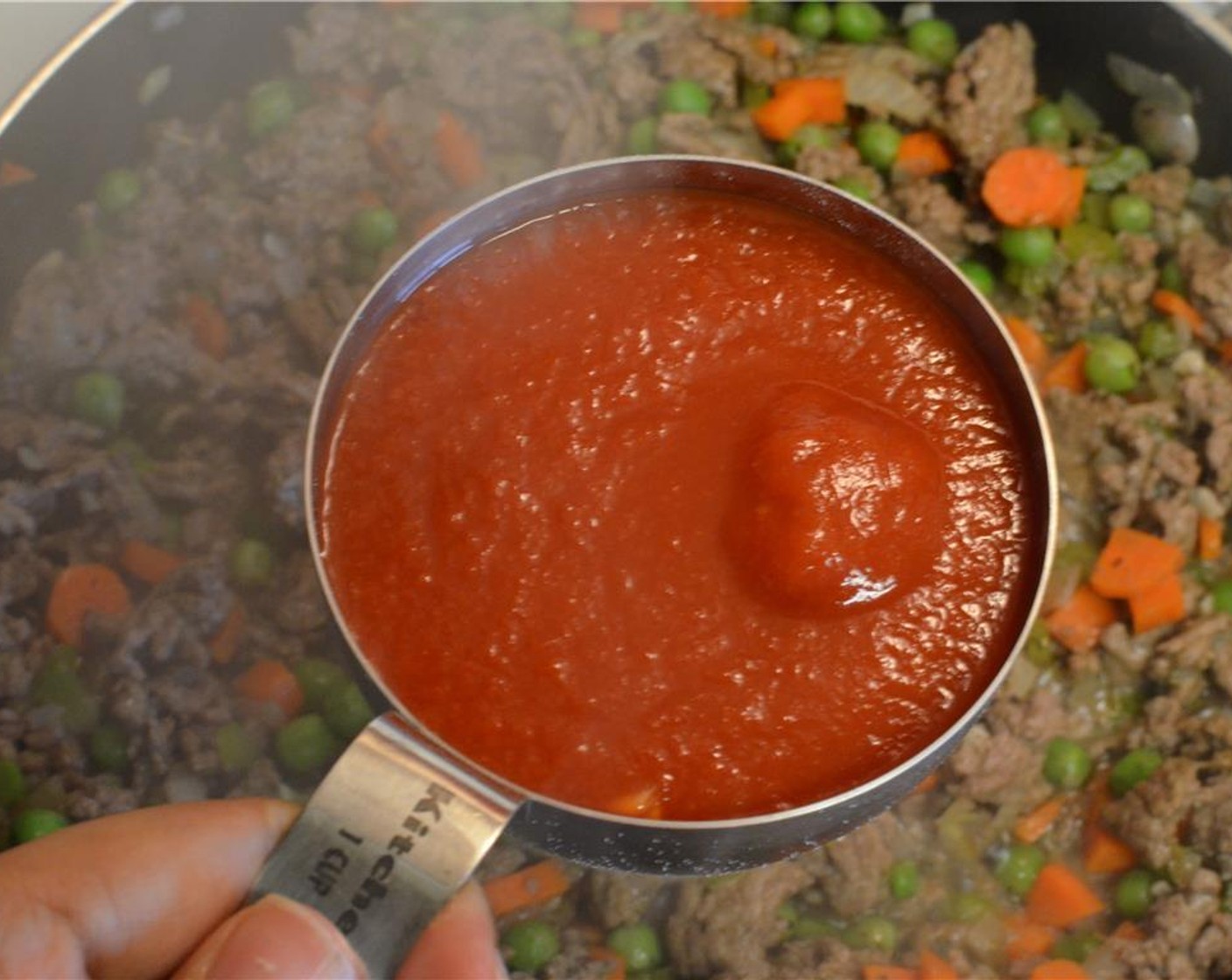 step 7 Then pour in Tomato Sauce (1 cup) mix well and bring to a boil. Then put a lid on, lower the heat and let the sauce simmer for 10 minutes. Just before you turn off the heat, stir in some finely chopped Fresh Parsley (1 handful).