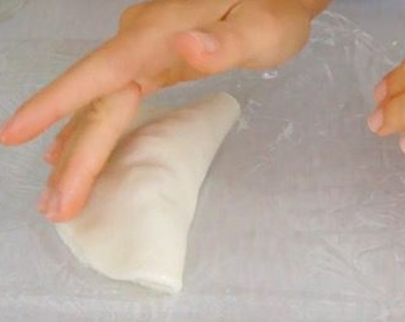 step 10 Add 1.5 tbp of the chicken filling and fold using the cling film to help you.
Using a soup bowl cut the edges of the empanada so it's sealed completely and leaves a nice border.