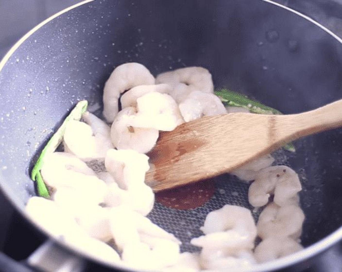 step 3 In a deep pan, heat up Coconut Oil (2 tsp) until melted, then add Mustard Seeds (1/4 tsp), Green Chili Peppers (2), Curry Leaf (1), King Prawns (1.1 lb) and Asafoetida (1/2 tsp).