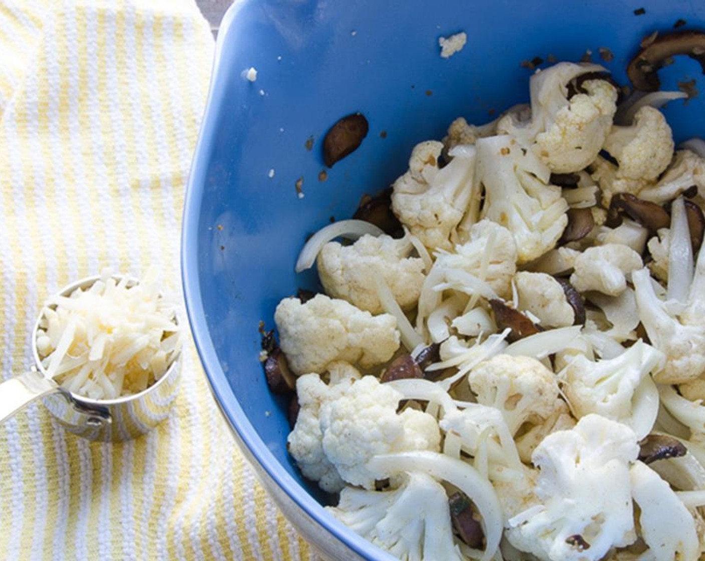 step 6 Peel and thinly slice the Onion (1). Cut the Cauliflower (4 cups) into bite sized florets. In a large bowl combine the cauliflower and onions. Add the remaining 2 tablespoons of olive oil, Kosher Salt (1/2 tsp) and Ground White Pepper (1/4 tsp) and toss to coat.