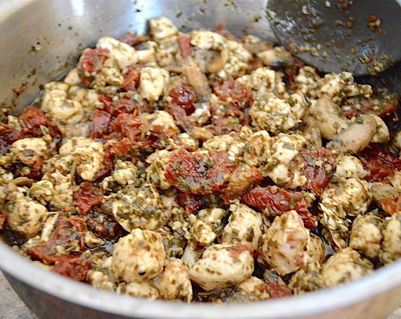 step 4 Add the Boneless Skinless Chicken (1 lb) and let it completely cook while you stir it well. Season the entire mixture with Salt (1 pinch), Freshly Ground Black Pepper (1 pinch), McCormick® Garlic Powder (1 pinch), and Dried Parsley (1 pinch). Once the chicken is cooked through, add the Basil Pesto (1 cup) and let it all gently simmer together on low for 5 minutes. Take it off of the heat and set it aside.