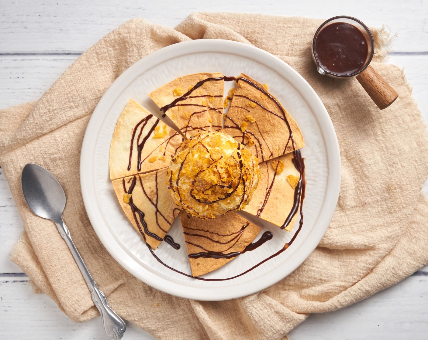 step 8 On a serving plate, place the tortillas. Then top with ice cream and pour the chocolate sauce mixture on top. Serve immediately.