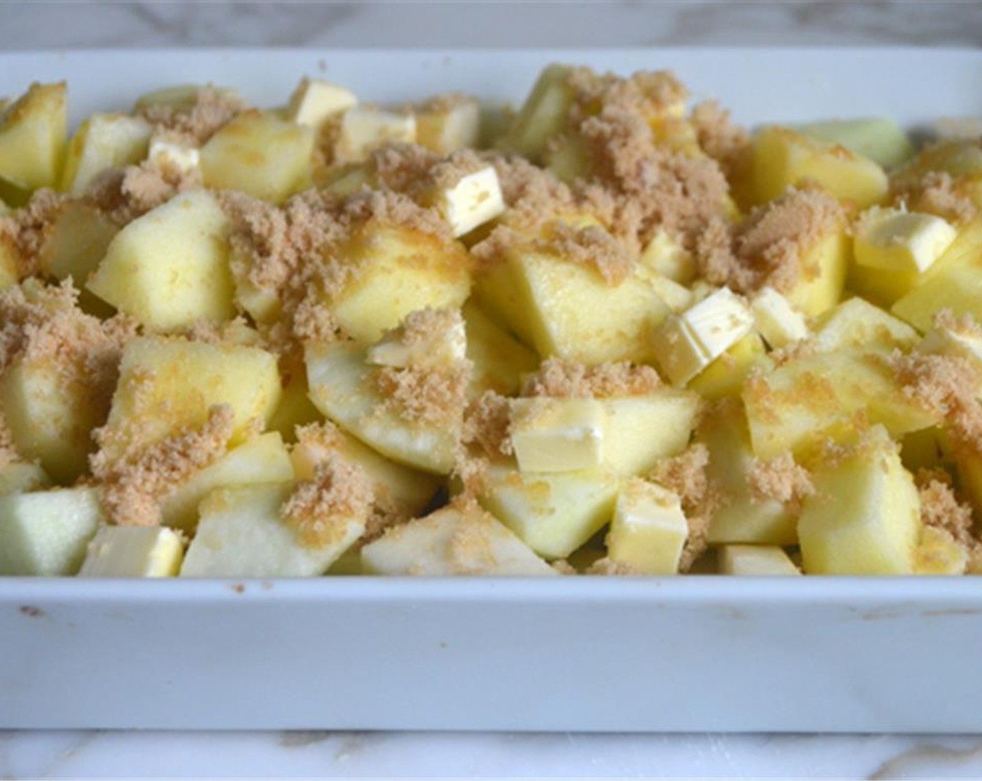 step 4 Place the apples in a 9x13-inch baking dish. Scatter the Brown Sugar (1/3 cup) and chunks of butter evenly over top.