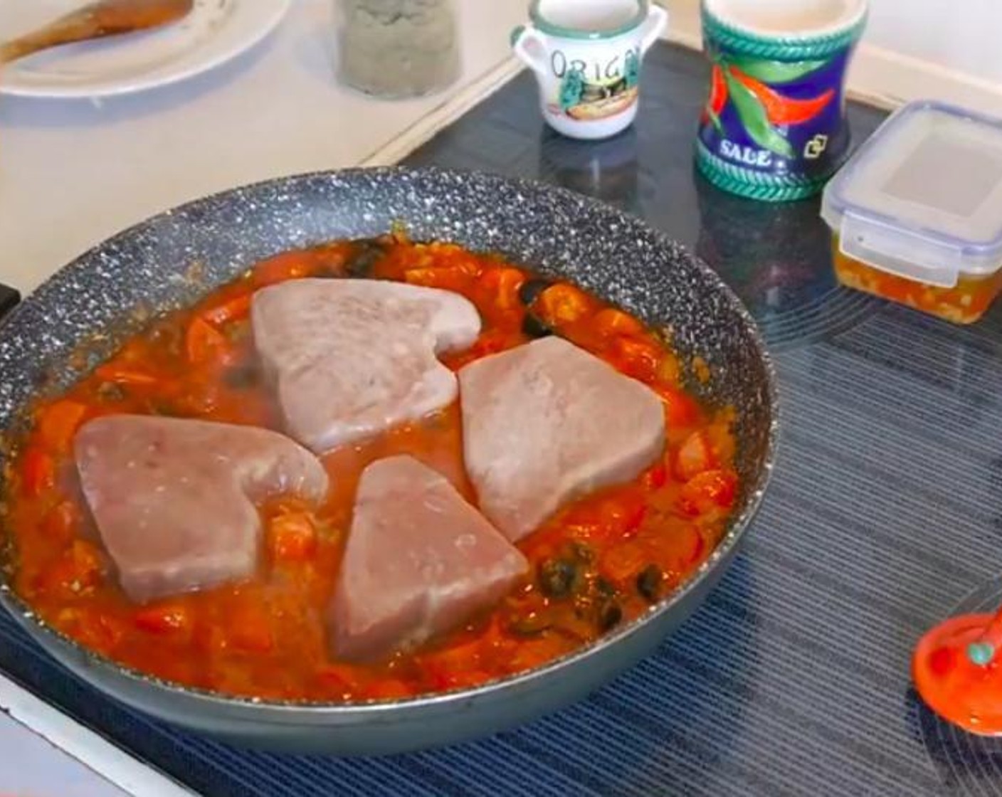 step 4 Using your spoon open some space within the sauce and add the Fresh Tuna Steak (4). If you're using frozen tuna you can add them from frozen. Add 1 tsp of Venezuelan Chili Salsa (2 2/3 Tbsp) over each steak and sprinkle some salt or sea salt. Cover and leave to cook for 4 to 5 minutes.