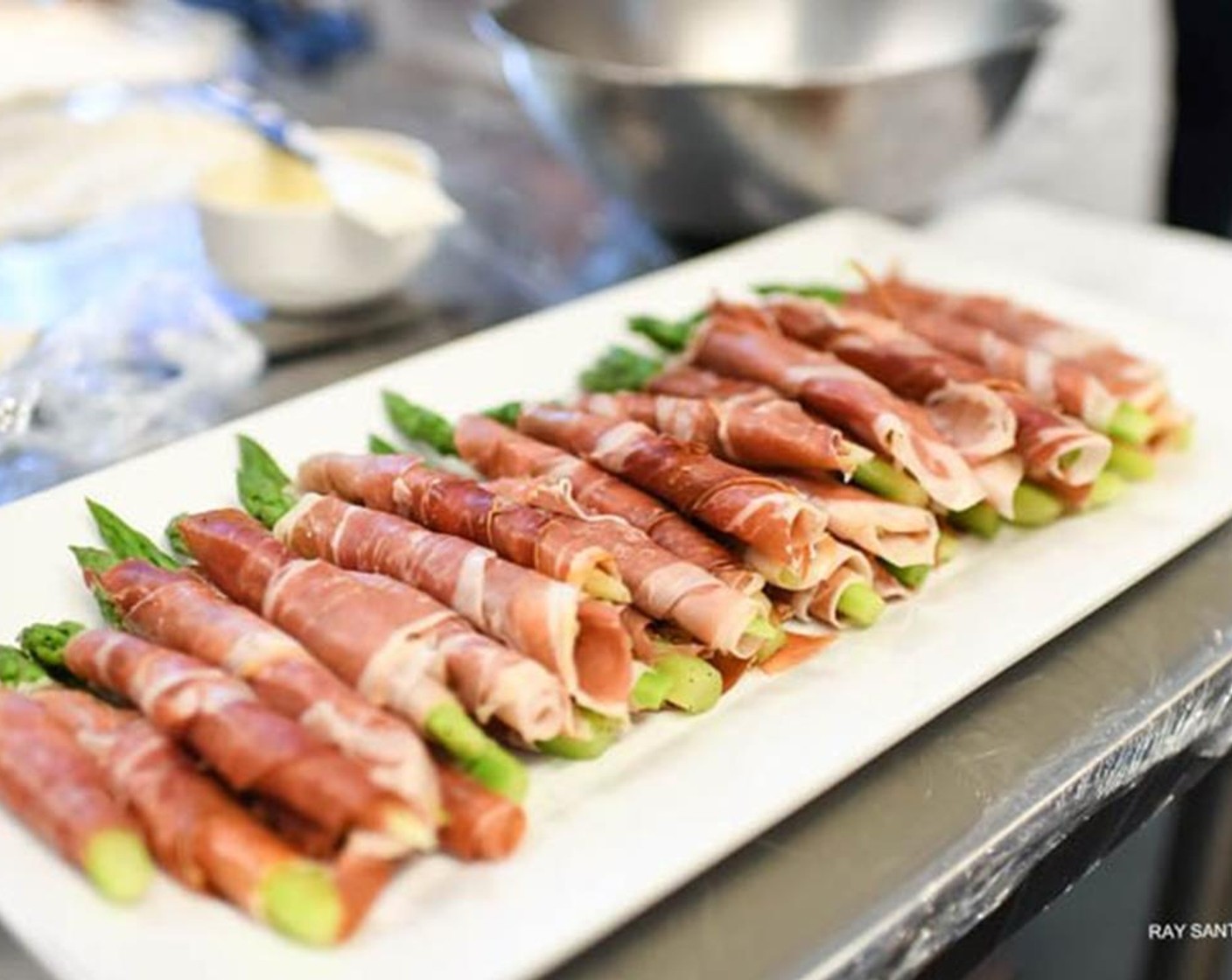 step 4 Sprinkle the asparagus spears with Ground Black Pepper (to taste). Wrap each asparagus spear with Iberico Iberico Ham (6 slices) allowing the tip of the asparagus to show through at the top.