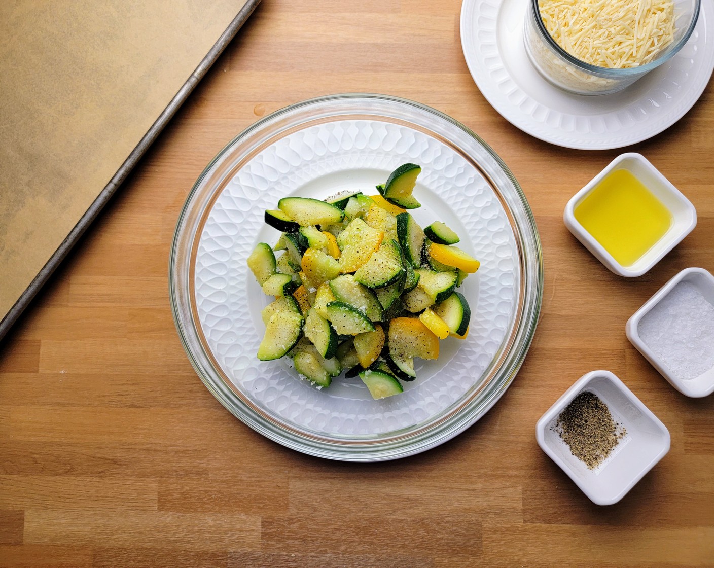 step 2 Place the Frozen Zucchini Blend (2 cups) in a bowl and toss with Olive Oil (1 Tbsp), Kosher Salt (1 tsp), and Ground Black Pepper (1 tsp).