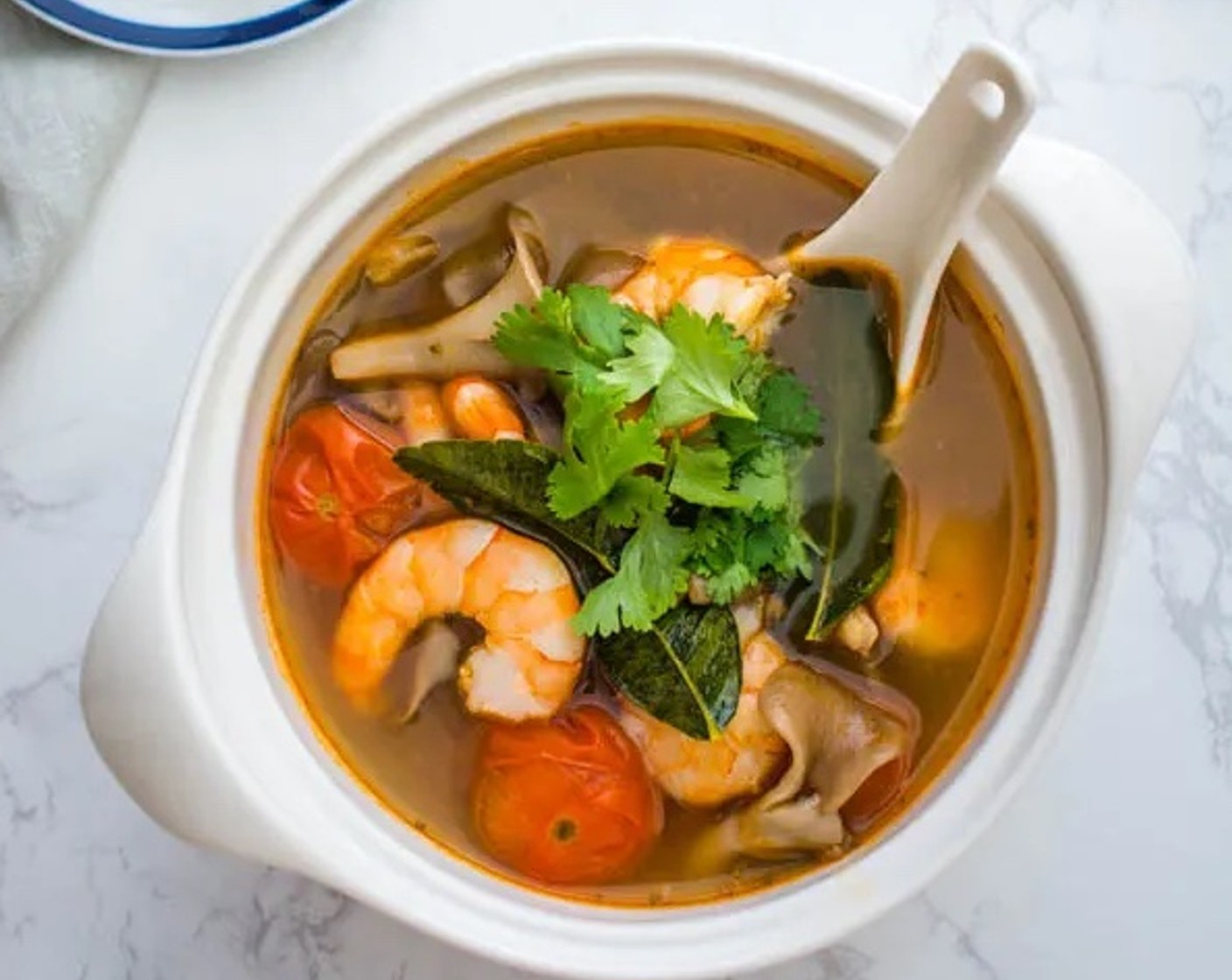 step 5 When the shrimp are cooked, transfer the soup to a serving bowl. Garnish with Fresh Cilantro Leaves (as needed). Serve immediately with lime wedges on the side. Enjoy!