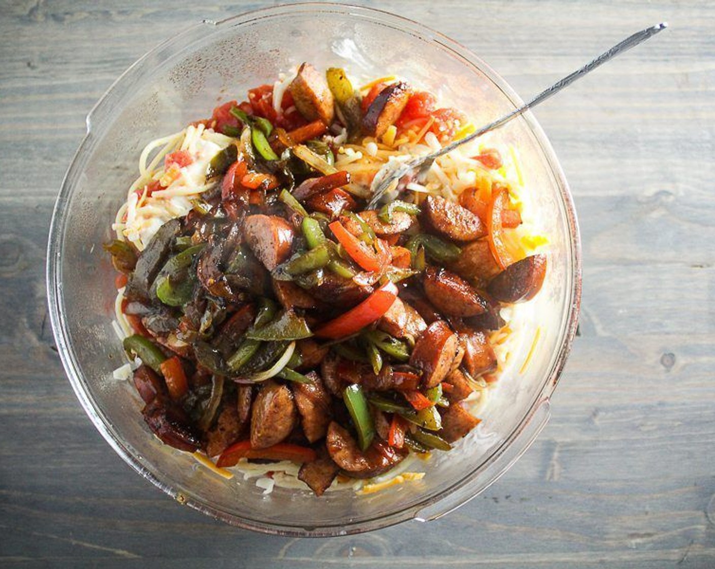 step 7 In a large bowl or pan, combine the pasta, Ro-Tel® Diced Tomatoes & Green Chilies (1 1/2 cups), Cream of Mushroom Soup (10.5 oz). Frank's® RedHot® Sauce (1/2 Tbsp), Cajun Seasoning (1 tsp), Ground Black Pepper (1/4 tsp), Cayenne Pepper (1/8 tsp), half of the Medium Cheddar Cheese (3/4 cup), and half of the Monterey Jack Cheese (3/4 cup). Add pasta water and stir to combine well.