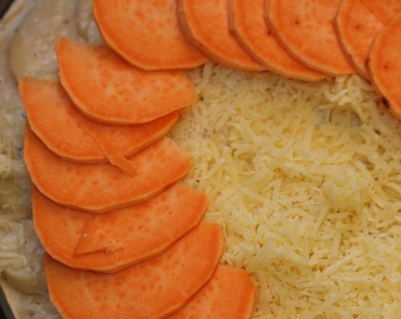 step 5 Pour ½ cup of the cream mixture on the bottom (this helps keep the potatoes from sticking to the bottom and burning). Layer one layer of sweet potato slices in a circular pattern, overlapping them slightly.