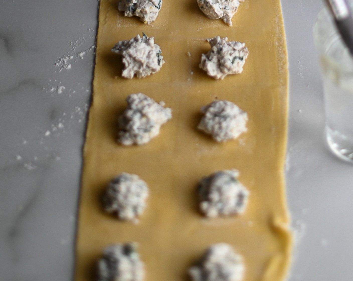 step 7 Spoon the chilled ricotta mixture along with the pasta sheet, working in 10 ml dollops spaced equidistantly to allow for an edge.