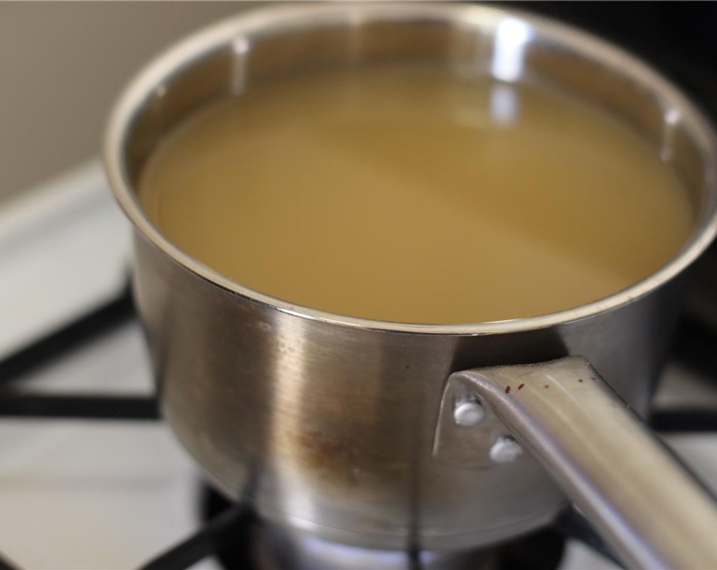 step 7 Heat the Chicken Broth (4 cups) in a pot over low heat. Place a stainless steel baking rack on top of a baking sheet. Spray it with cooking spray.