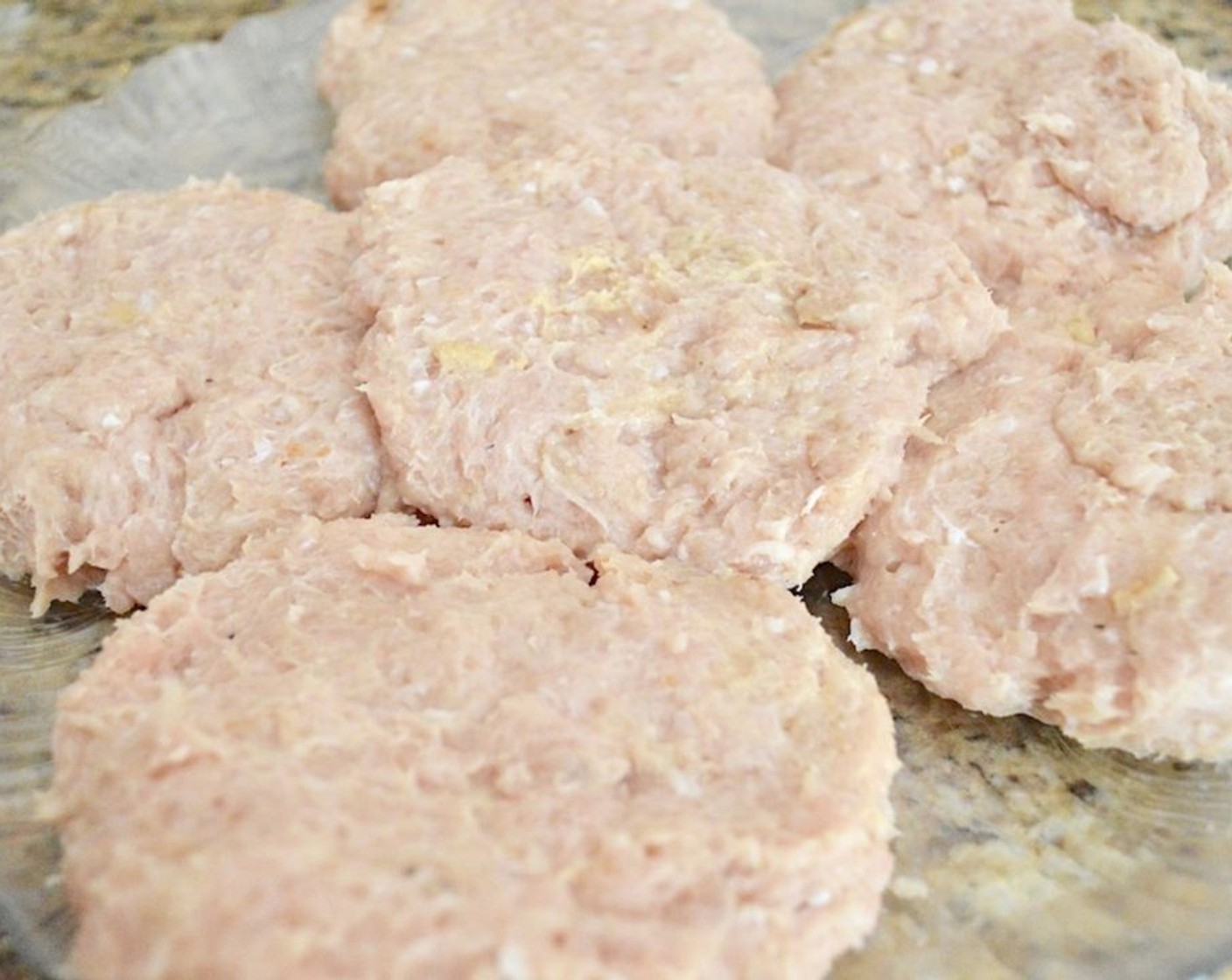 step 4 Combine the Ground Chicken (2 lb), French Onion Soup Powder Mix (1 Tbsp), Dijon Mustard (1 Tbsp), Ground Cumin (1 tsp), Simply Organic Garlic Powder (1 tsp), Salt (1 pinch), and Ground Black Pepper (1 pinch) in a bowl and work it all together thoroughly with clean hands. Form the mixture you made into 6 equal patties.