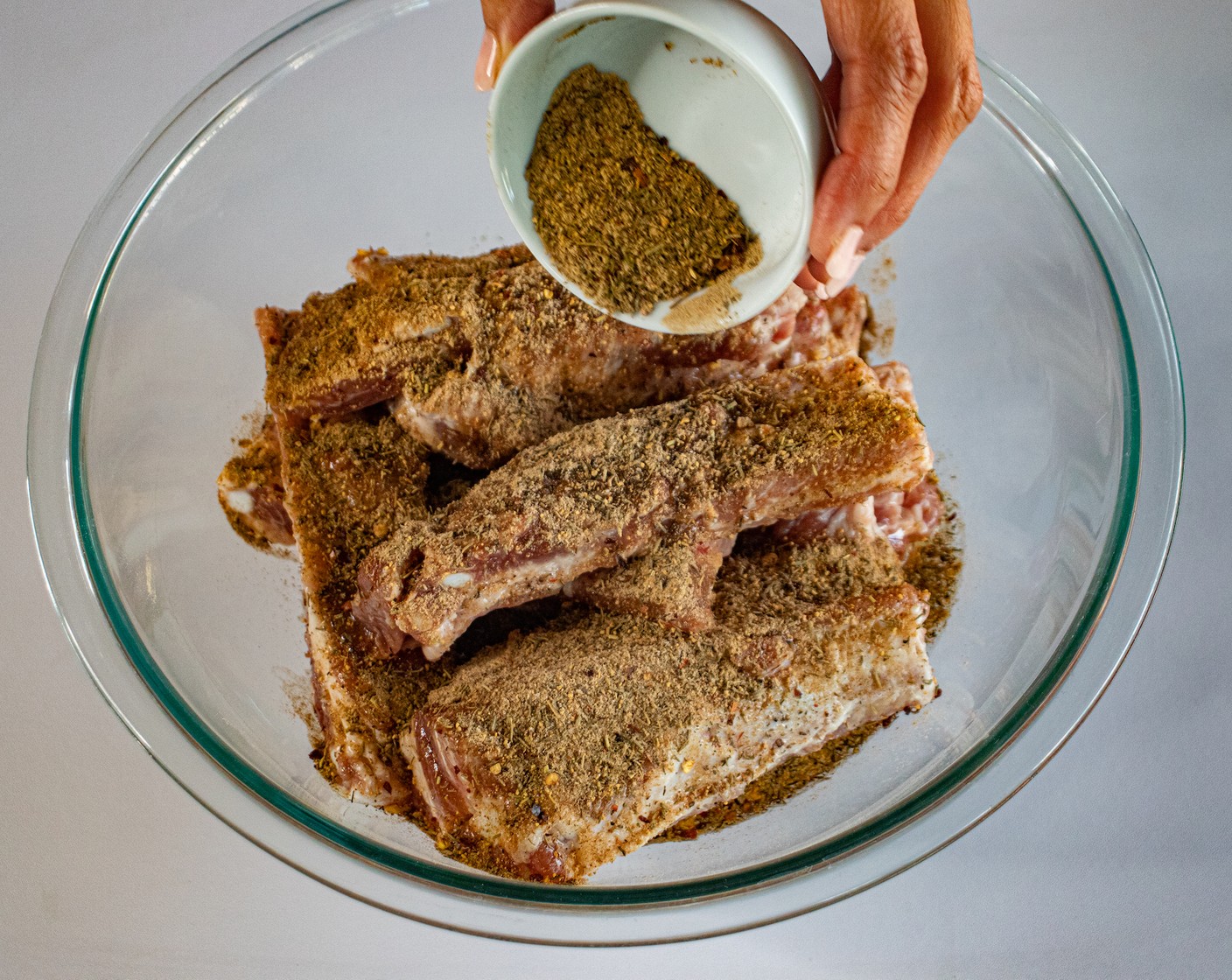 step 4 Season ribs with Olive Oil (4 Tbsp) and Adobo Seasoning (4 Tbsp). Mix well.